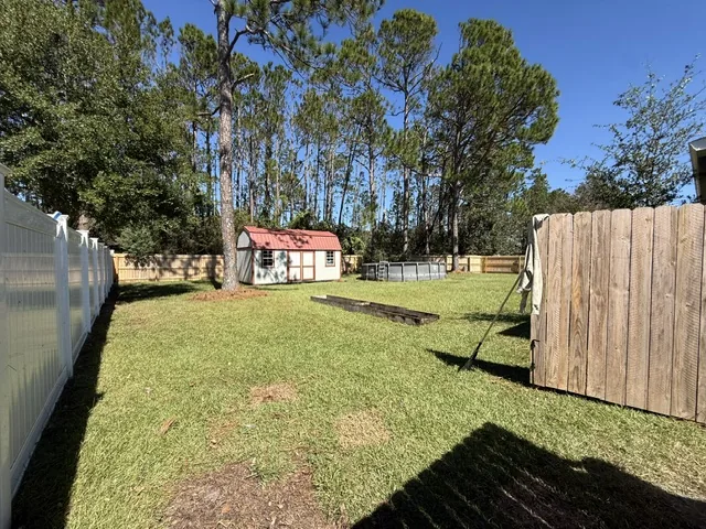 After: backyard by the shed, raked and clean